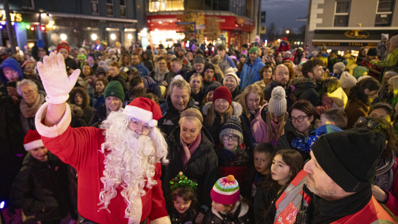 Santa Claus standing in front of a crowd of people