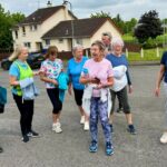 Participants from the Connecting Communities Through Wellbeing Programme enjoying a Walking For All event, promoting physical activity, wellbeing, and community connection.